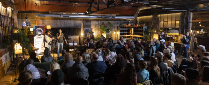 Full audience of people listens to the emcees