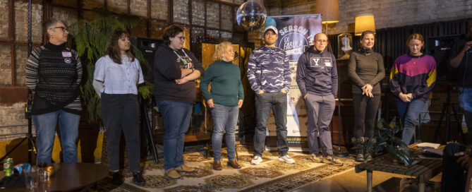 8 StorySlam finalist stand in a row