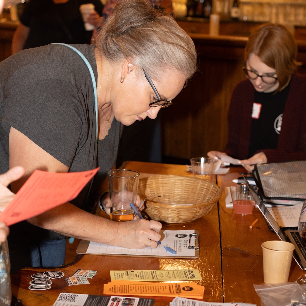 Person writing on a clipboard